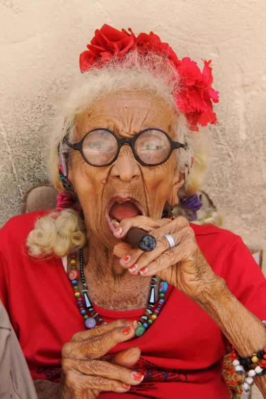 an old woman with glasses eating a donut, by artist, pexels contest winner, cuban setting, very long fingernails, square, wrinkled face