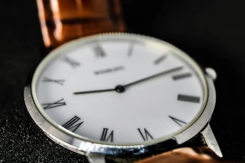 a close up of a wrist watch with roman numerals, pexels contest winner, bauhaus, gradient brown to silver, white, medium close shot, on display