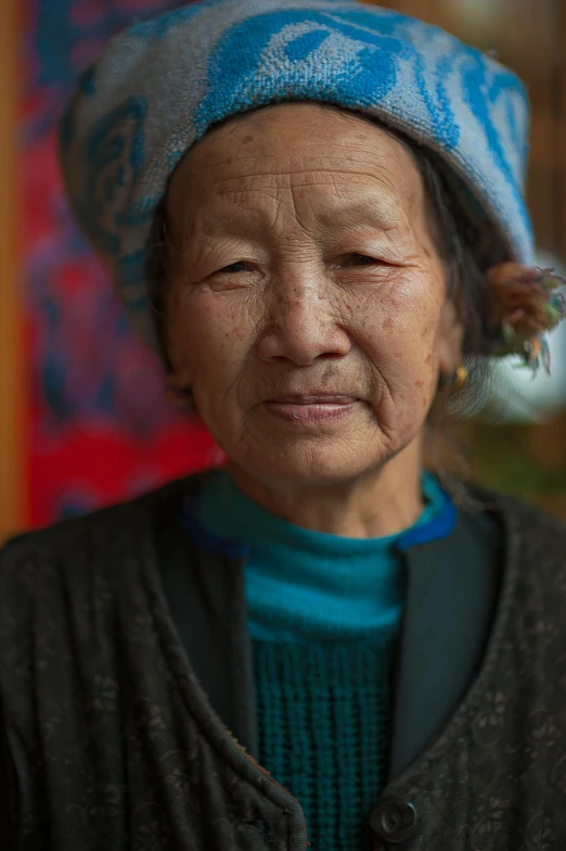 a close up of a person wearing a hat, a portrait, pexels contest winner, cloisonnism, nepal, portrait of christy ren, taken in the late 2010s, photo of a woman