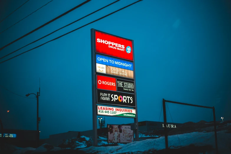 a gas station sign sitting on the side of a road, by Alexander Bogen, pexels contest winner, happening, shopping mall, busy night, yeg, plain background