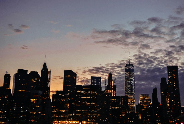 the city skyline is lit up at night, pexels contest winner, late afternoon light, instagram post, new york times, background image