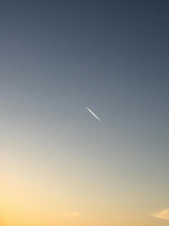 a plane flying over the ocean at sunset, by Niko Henrichon, postminimalism, meteor, uniform off - white sky, shooting star, minimalist photorealist