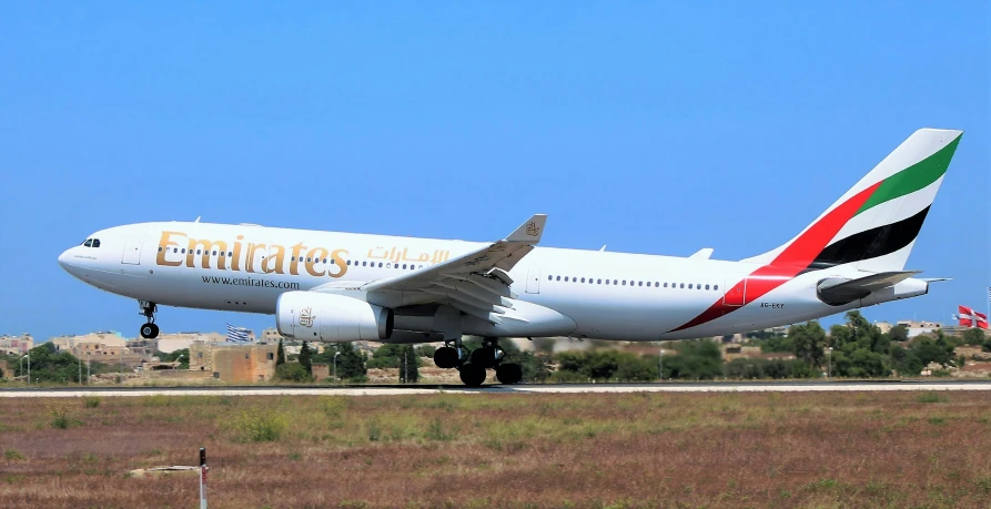 a large jetliner sitting on top of an airport runway, pexels contest winner, arabesque, red and gold, cyprus, panoramic, ready to eat