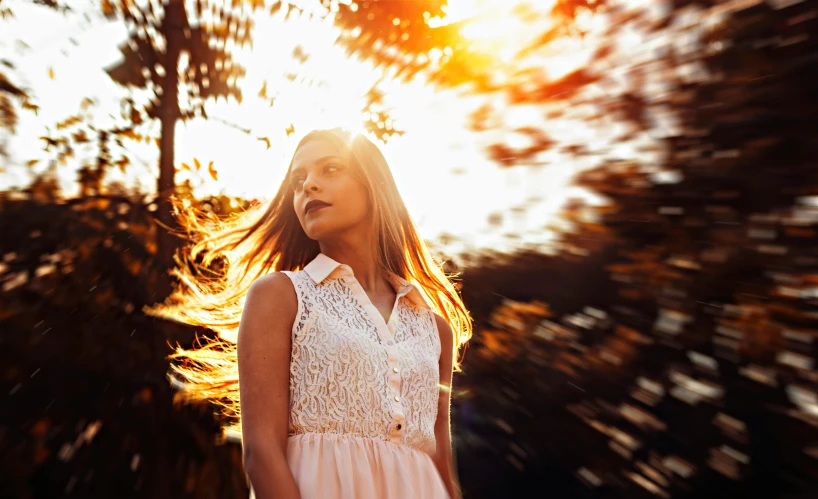 a woman with her hair blowing in the wind, by Matt Cavotta, pexels contest winner, sun flairs, light dress, golden hour 4k, pink sunlight