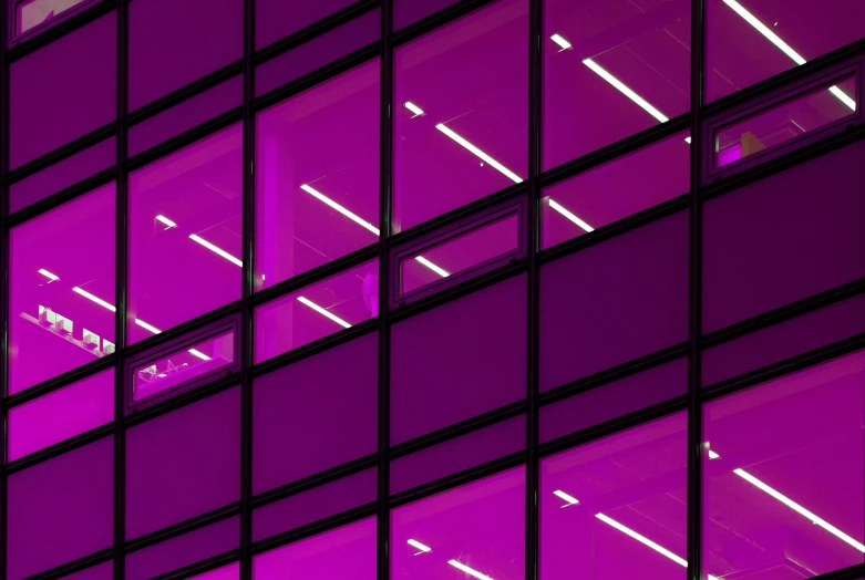 a clock on a pole in front of a building, inspired by Andreas Gursky, unsplash, light and space, brightly lit purple room, rows of windows lit internally, magenta, lit. 'the cube'