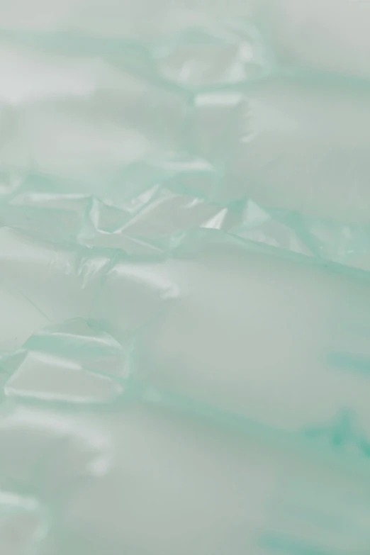 a close up of a piece of glass on a table, inflatable, seafoam green, soft opalescent membranes, detailed product shot