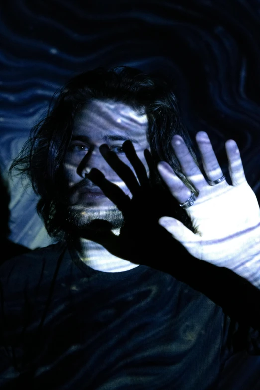 a close up of a person in a body of water, an album cover, inspired by John Carpenter, hand gesture, jay bauman, black light, dreamy