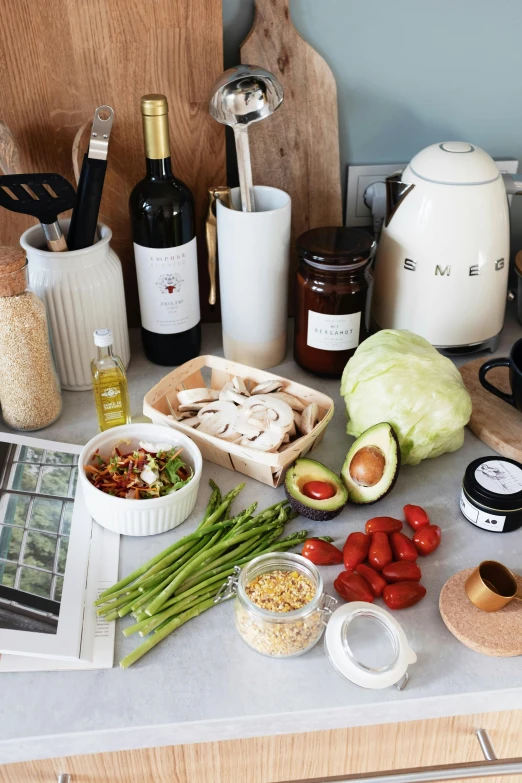 a counter topped with lots of different types of food, by Alice Mason, unsplash, renaissance, white wine bottle, homes and garden magazine, on kitchen table, veggies