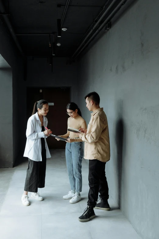 a group of people standing next to each other, pexels contest winner, modernism, inspect in inventory image, (doctor), ren heng, on a black wall