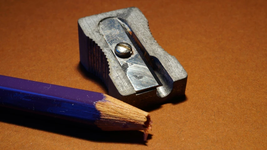 a pencil and a sharper on a table, by David Simpson, pixabay, photorealism, box cutter, color graflex macro photograph, 1999 photograph, burnt umber and blue