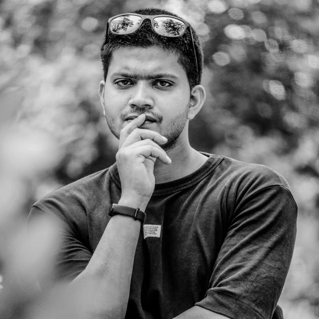 a black and white photo of a man with sunglasses, a black and white photo, by Max Dauthendey, pexels contest winner, realism, jayison devadas, casual pose, slightly pixelated, young commoner
