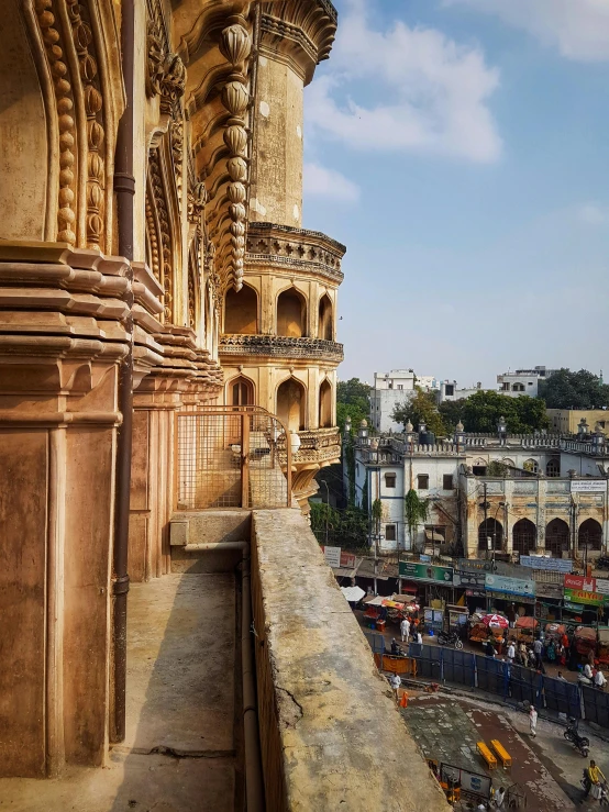 a view of a city from the top of a building, pexels contest winner, bengal school of art, arches adorned pillars, profile pic, castles and temple details, street level view