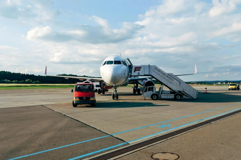 a large jetliner sitting on top of an airport tarmac, by Matthias Stom, pexels contest winner, flying emergency vehicles, thumbnail, hd footage, summer morning