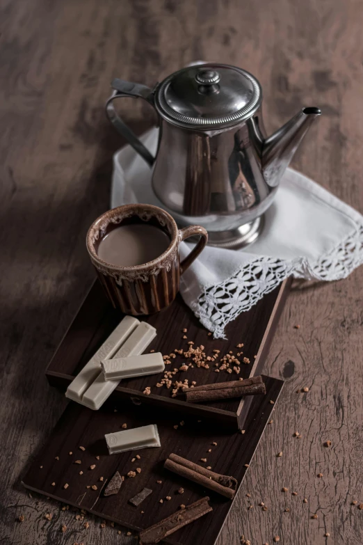 a tea pot sitting on top of a wooden table, chocolate, thumbnail, silver, jakarta
