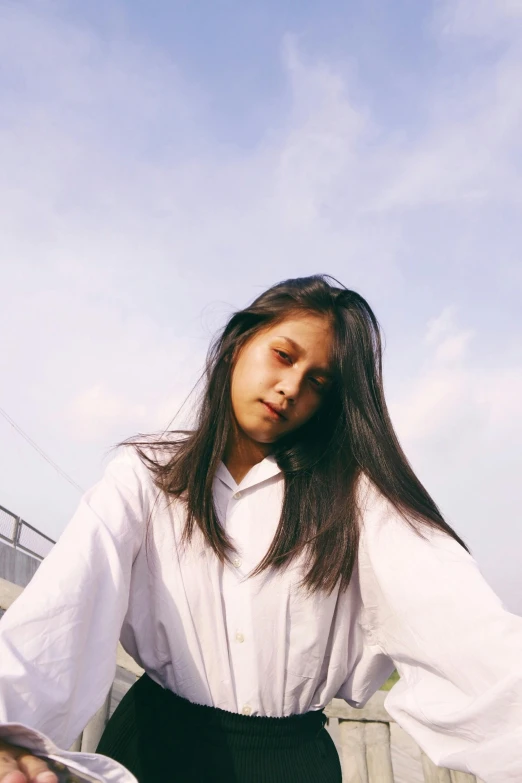 a woman in a white shirt and black skirt, inspired by Ren Hang, unsplash, realism, long flat hair, uniform off - white sky, south east asian with round face, wearing white pajamas