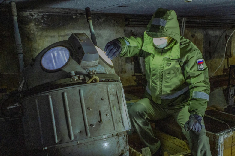 a man in a green uniform working on a machine, shutterstock, nuclear art, full body armour, underground bunker, instagram photo, freezing