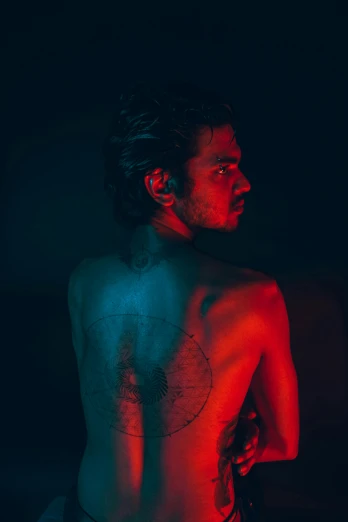 a man with a tattoo on his back, an album cover, pexels contest winner, conceptual art, low saturated red and blue light, provocative indian, symmetrical face orelsan, tracers