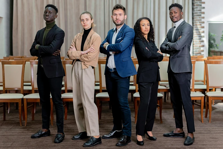 a group of business people standing next to each other, a portrait, by Bernard D’Andrea, pexels contest winner, avant designer uniform, confident pose, jury, varying ethnicities