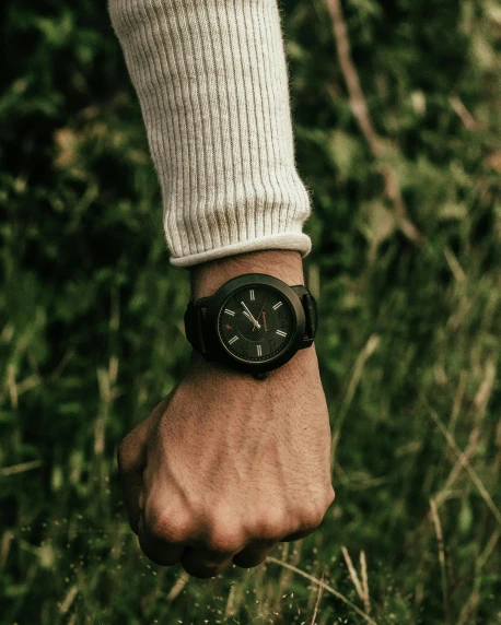 a close up of a person wearing a wrist watch, in the wood, green and black, curated collections, rugged ranger