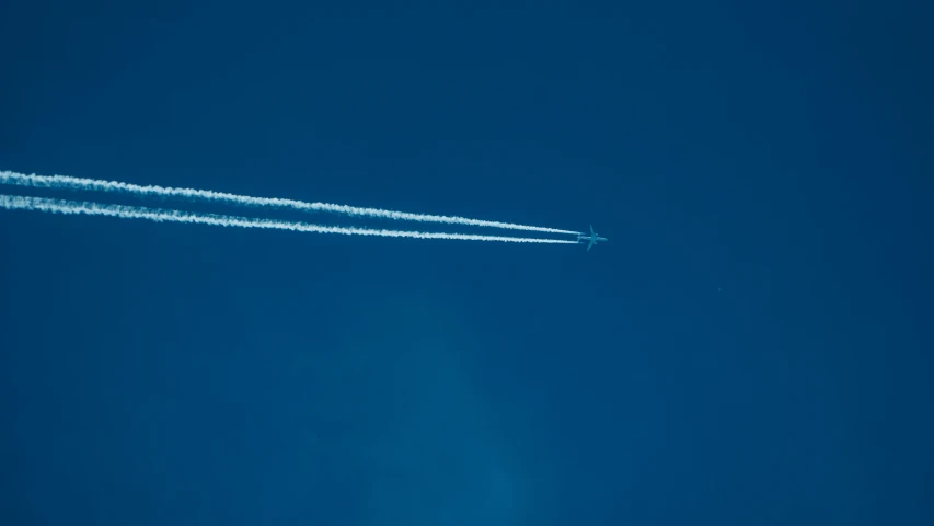 an airplane is flying in the blue sky, by Niko Henrichon, minimalism, particulate, thumbnail, space photography, no sky
