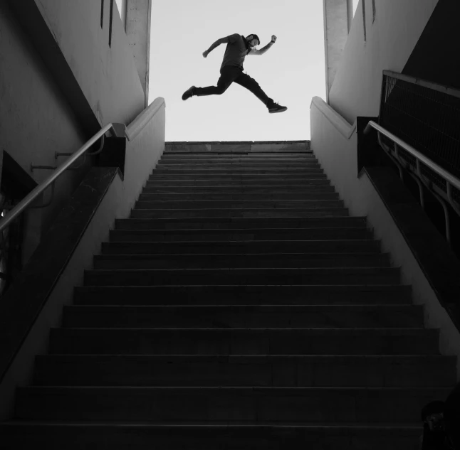 a man flying through the air while riding a skateboard down a flight of stairs, a black and white photo, by Jean-Yves Couliou, unsplash contest winner, conceptual art, saatchi art, silhouette :7, stairs from hell to heaven, anna nikonova