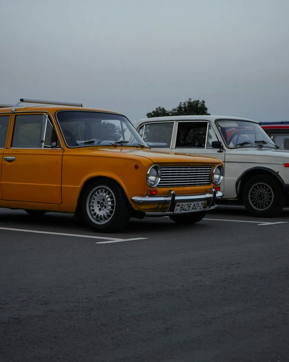 a group of cars parked next to each other in a parking lot, by Sven Erixson, unsplash, russian lada car, white and yellow scheme, early evening, 15081959 21121991 01012000 4k