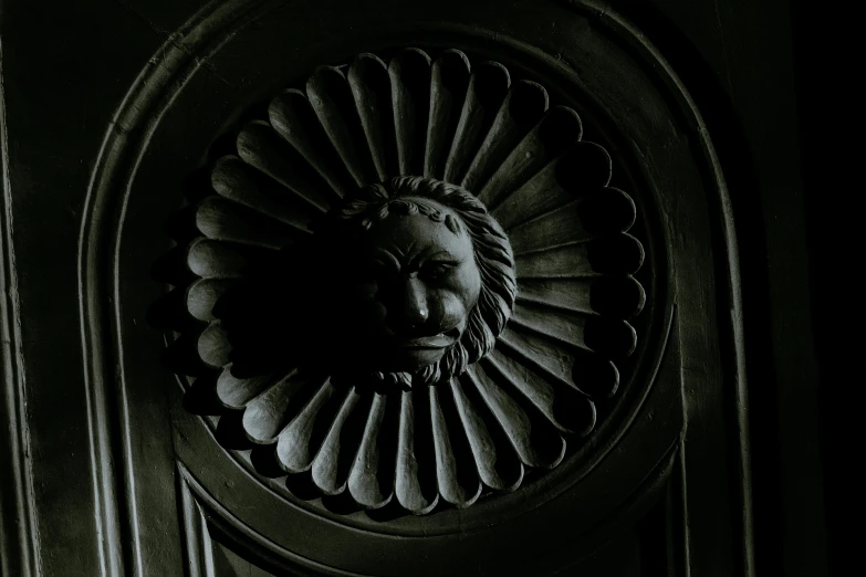 a black and white photo of a lion head on a door, inspired by Gustav Doré, pexels contest winner, gothic art, round doors, dark photograph, green man, low-light photograph