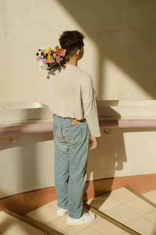 a woman standing in a bathroom holding a bunch of flowers, by Nathalie Rattner, trending on pexels, artist wearing torn overalls, sun behind him, arched back, lookbook