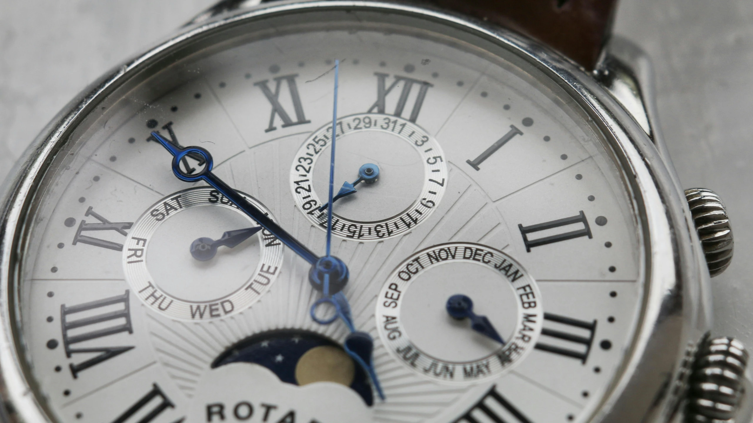 a close up of a wrist watch with roman numerals, analytical art, fan favorite, lunar cycles, shot with sony alpha, full width