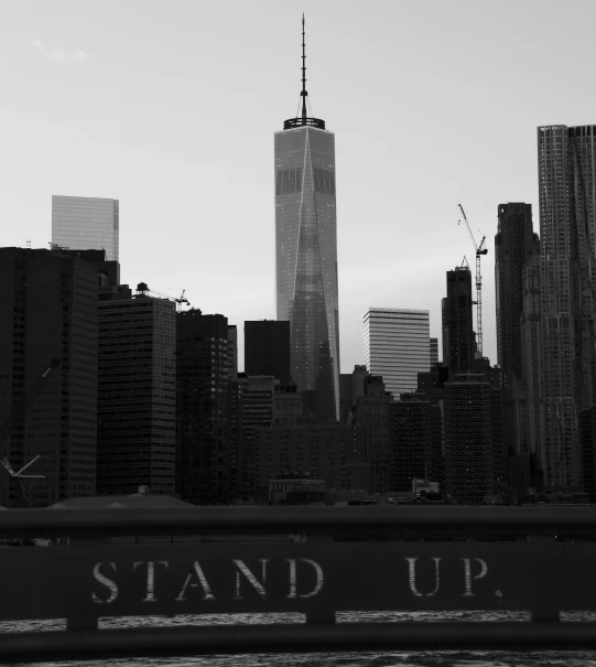 a black and white photo of a city skyline, a black and white photo, by Stan Galli, unsplash, stand up with the sea behind, battle stand, 9/11, art stand