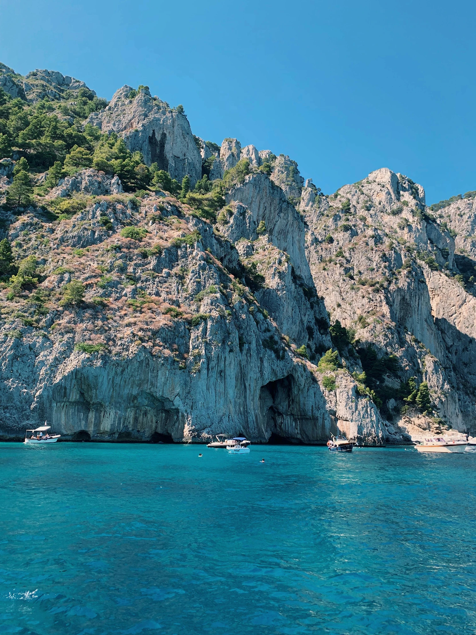 a body of water with a mountain in the background, capri coast, thumbnail, epic land formations, slide show