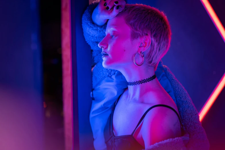 a woman that is standing in front of a mirror, inspired by Elsa Bleda, trending on pexels, realism, blue lights and purple lights, lil peep, annie leonhart in a neon city, color ( sony a 7 r iv