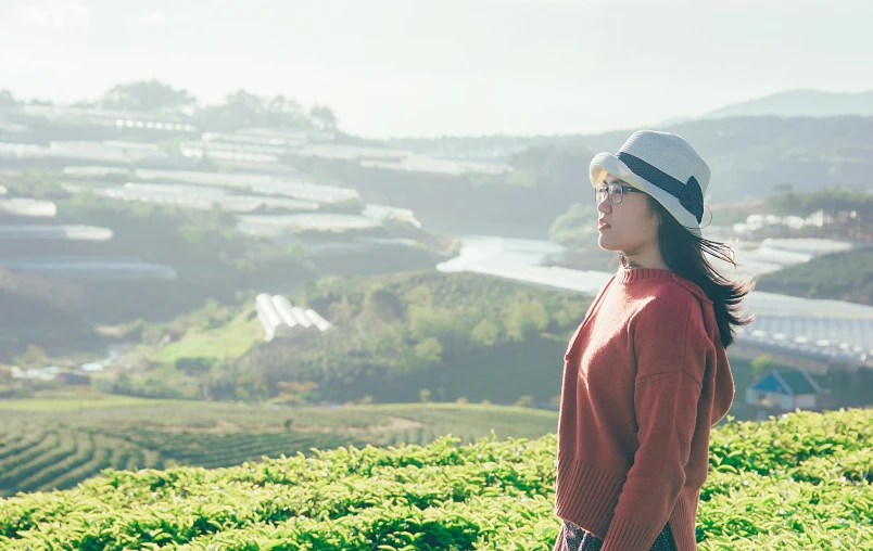 a woman standing on top of a lush green hillside, inspired by Ma Yuanyu, pexels contest winner, happening, secret tea society, wearing sunglasses and a hat, avatar image, beautiful young korean woman