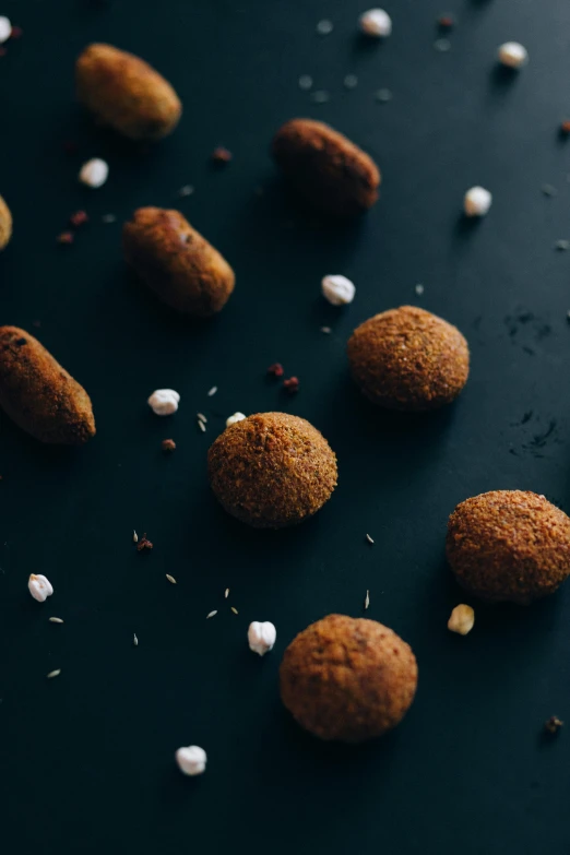 a bunch of food sitting on top of a table, a digital rendering, by Julia Pishtar, unsplash, hurufiyya, asteroid belt, nugget, on a dark background, herbs