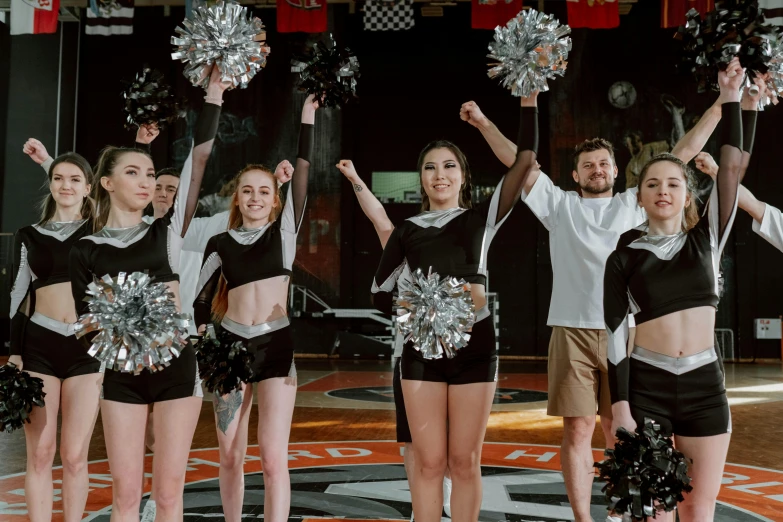 a group of young women standing on top of a basketball court, pexels contest winner, antipodeans, holding a pair of fans. unreal 5, black and silver, performing on stage, 15081959 21121991 01012000 4k