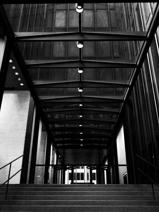 a black and white photo of the inside of a building, unsplash, shot with iphone 1 0, of mad men on madison avenue, dramatic lighting - n 9, walkway