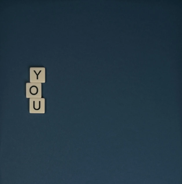a scrabble with the word you spelled on it, an album cover, inspired by Theo van Doesburg, unsplash, ffffound, dark blue, covid, yo
