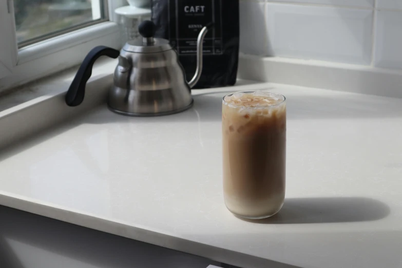 a cup of coffee sitting on top of a counter, iced latte, highly upvoted, angled, profile image