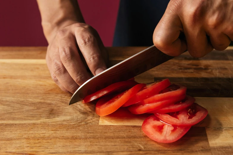 a person cutting tomatoes on a wooden cutting board, by Julia Pishtar, smoked layered, extra crisp image, guide, epicurious