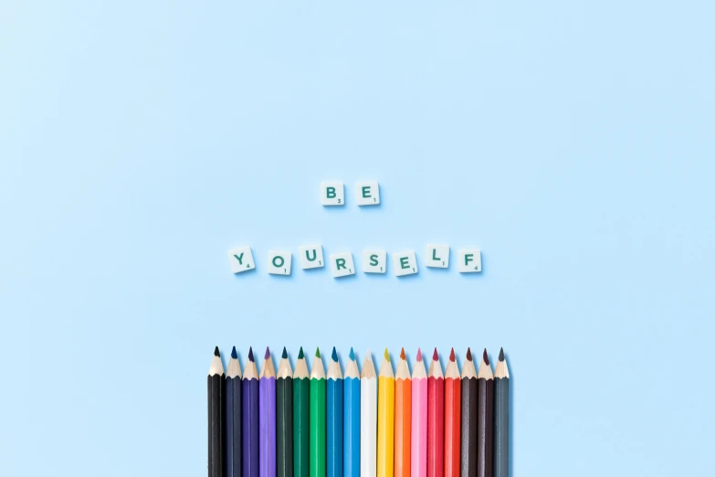 a group of colored pencils sitting next to each other, trending on pexels, crayon art, in white lettering, blue colour scheme, self-confidence, background image