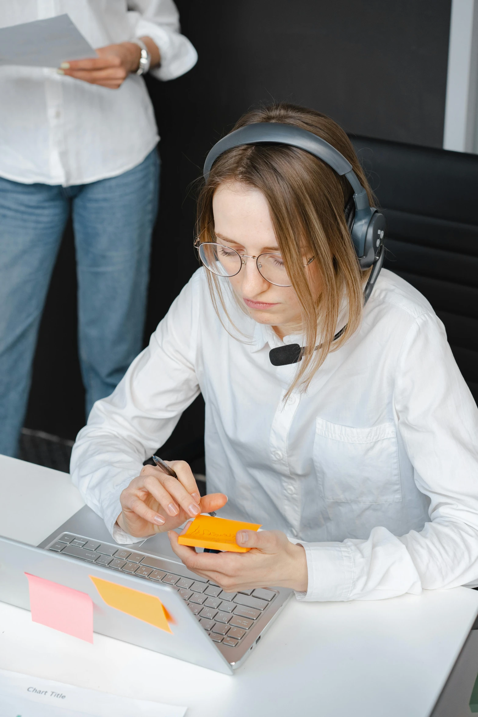 a woman sitting at a desk in front of a laptop computer, trending on pexels, wearing a gaming headset, teaching, low quality photo, rectangle