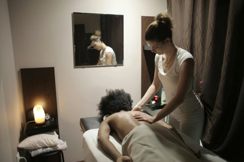 a woman getting a massage at a spa, by Matija Jama, pexels contest winner, massurrealism, poor quality, brown, thumbnail, male and female