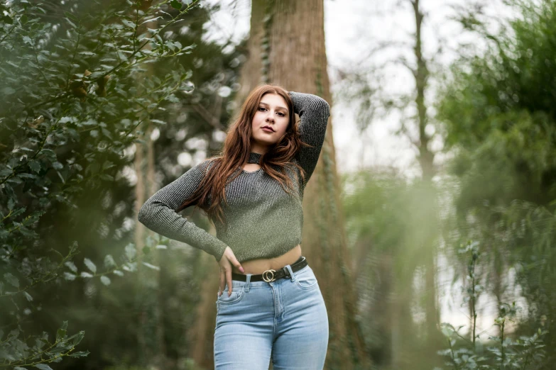 a woman posing for a picture in the woods, a portrait, pexels contest winner, black extremely tight jeans, portrait sophie mudd, 8k 50mm iso 10, eleanor tomlinson
