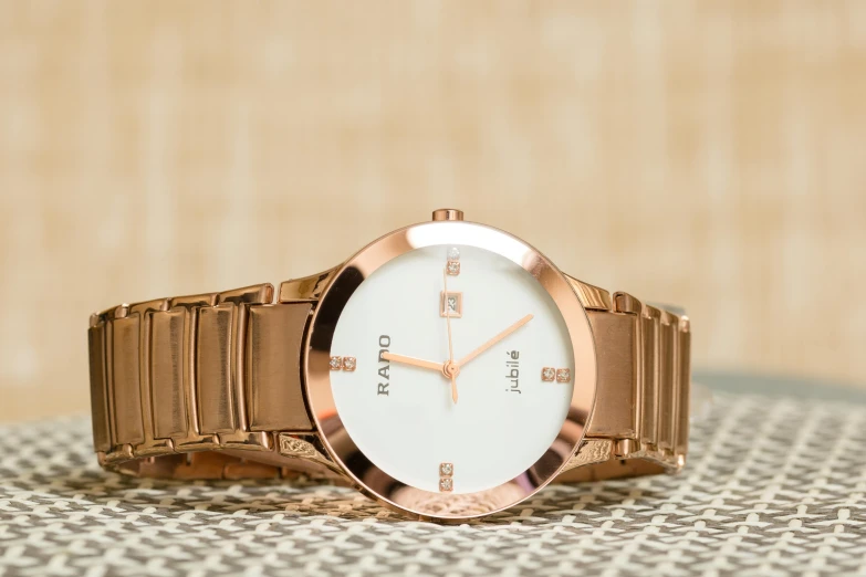 a close up of a wrist watch on a table, an album cover, trending on pexels, ivory and copper, bard, crisp clean shapes, amad