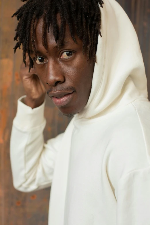 a man with dreadlocks wearing a white hoodie, inspired by Thomas Blackshear, trending on pexels, adut akech, looking to camera, thumbnail, 2 1 savage