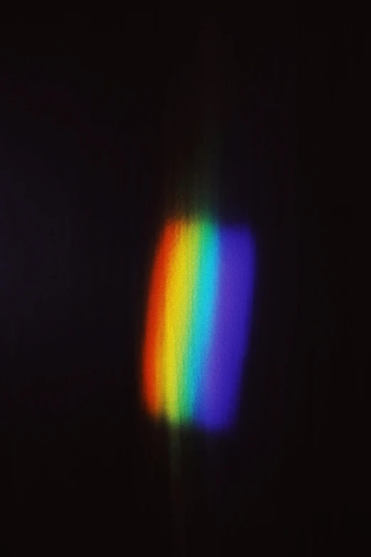 a rainbow colored light shines brightly on a black background, unsplash, holography, grainy low quality photograph, shot on a 2 0 0 3 camera, → ⃣ spectrum darkness prime, album cover