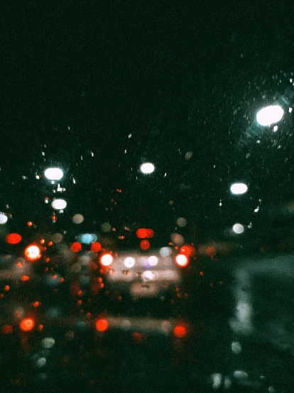 a street filled with lots of traffic at night, inspired by Elsa Bleda, rainy window, chillhop, ansel ]