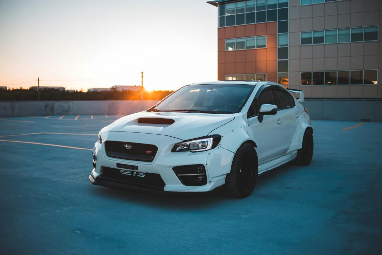 a white car parked in a parking lot, inspired by An Gyeon, subaru, golden hour 8k, thicc build, front of car angle