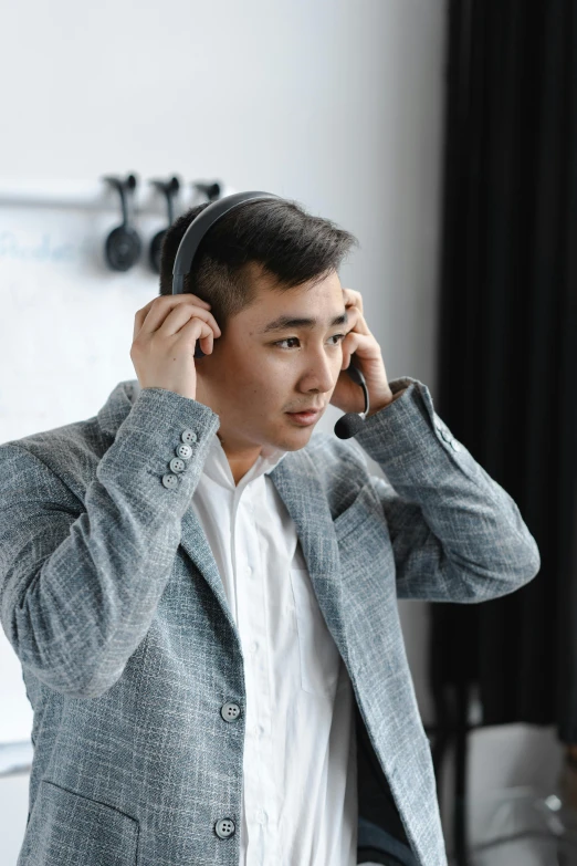 a man in a suit talking on a cell phone, wearing cat ear headphones, hoang long ly, work clothes, reddit post