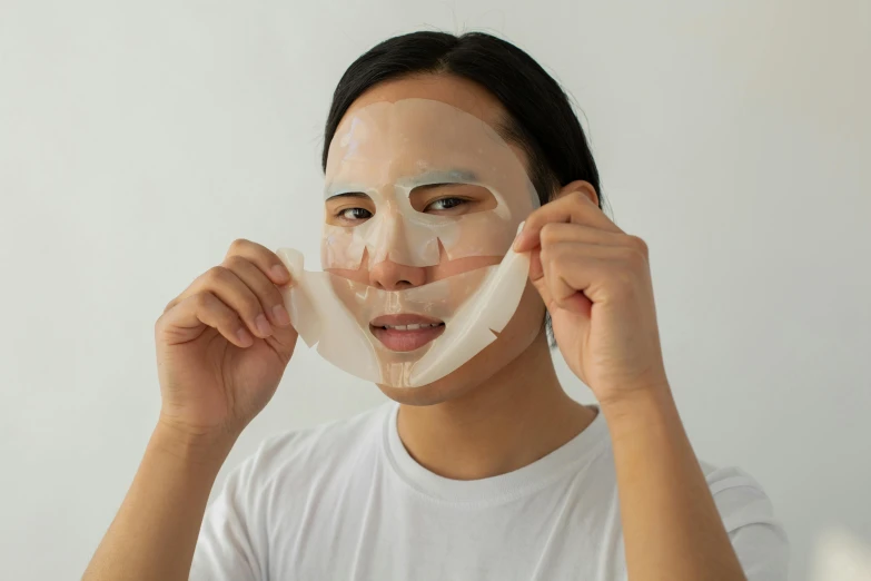 a woman putting a sheet mask on her face, hyperrealism, silicone skin, facing front, with clear glass, front on